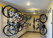 Thumbnail 3 of 10 - A bike rack with many bikes hanging on it.